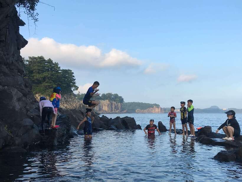 Jeju Island: Van Tour with a Guide Who Most Loves Jeju - Jeongbang Waterfall begins the sightseeing day