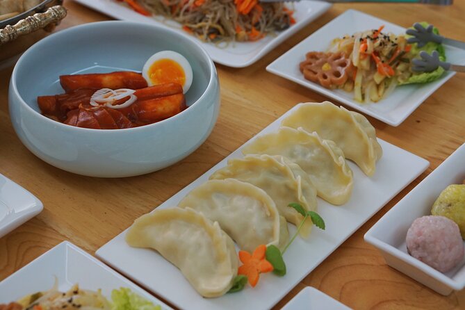 K-food cooking Japchae Mandu Tteokbokki & Fishcake - Four Korean favorites on one cooking table